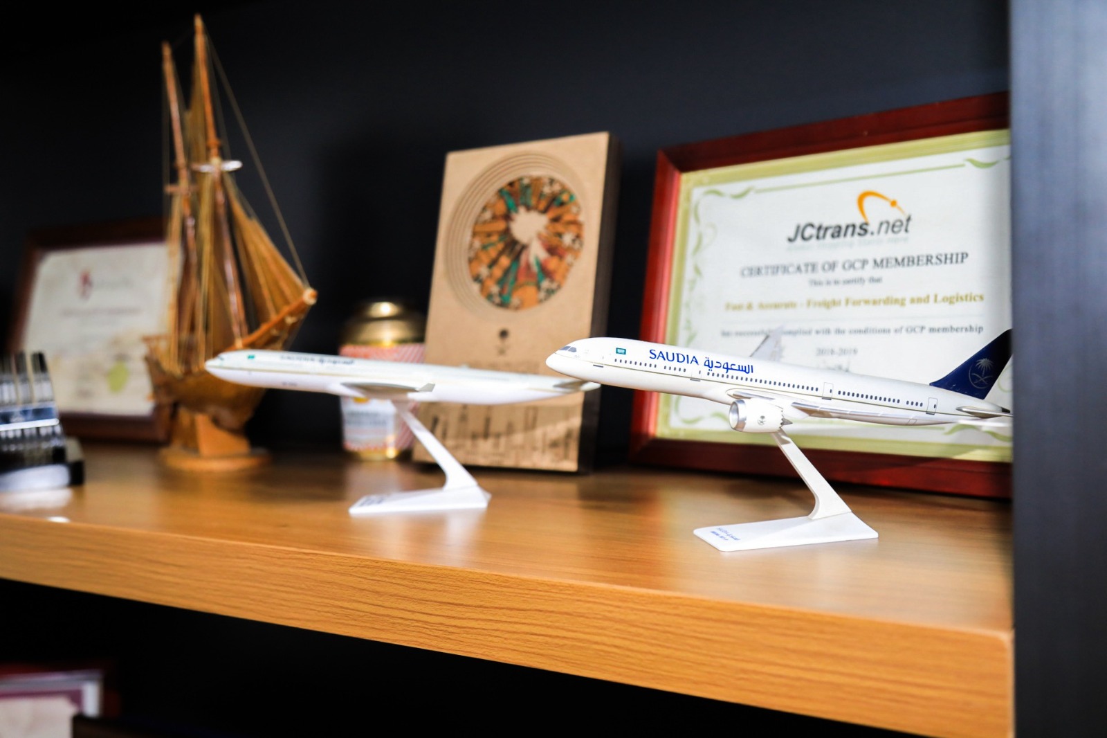 Aircraft models displayed beside the JCtrans GCP membership certificate