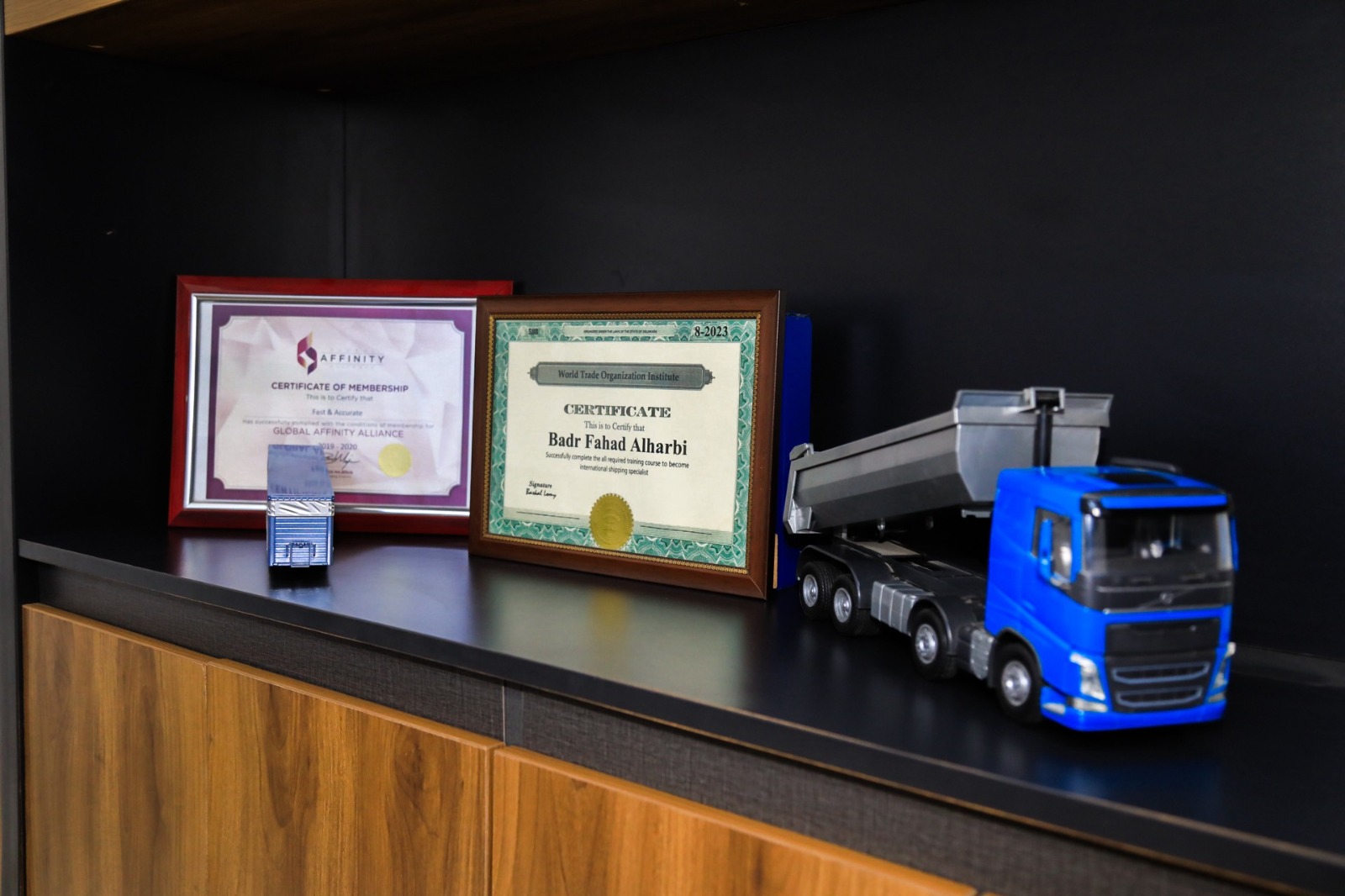Global Affinity Alliance membership and World Trade Organization Institute certificates on the office shelf
